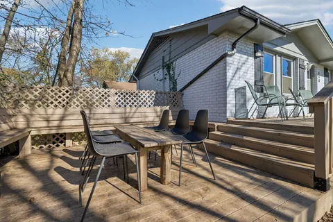 a backyard of a house with table and chairs