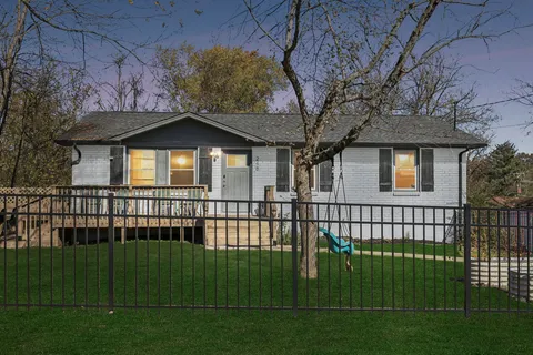 a front view of a house with a garden