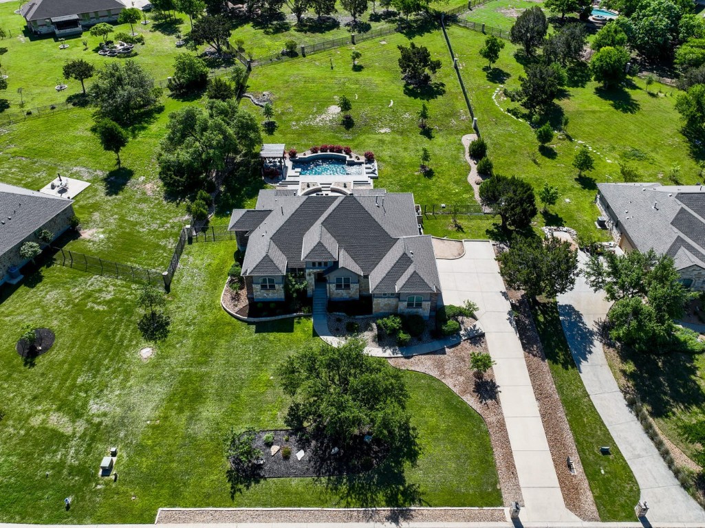 an aerial view of a house with yard green space
