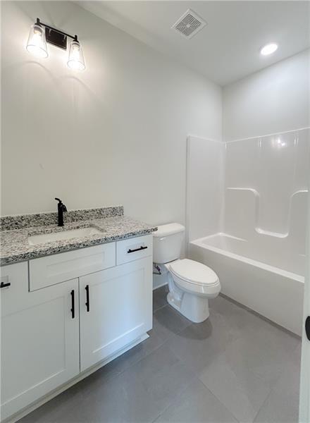 27 Bridgestone Way Cartersville, GA 30120 - Photo 20 of 31 a bathroom with a granite countertop toilet a sink and a bathtub