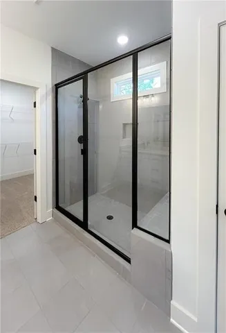 a bathroom with a glass shower door