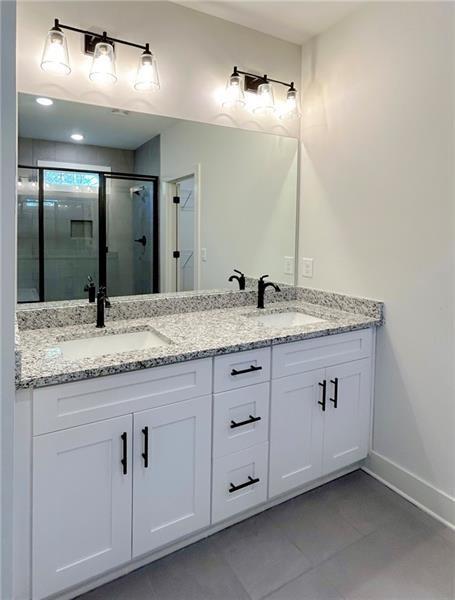 27 Bridgestone Way Cartersville, GA 30120 - Photo 28 of 31 a bathroom with a granite countertop double vanity sink and mirror