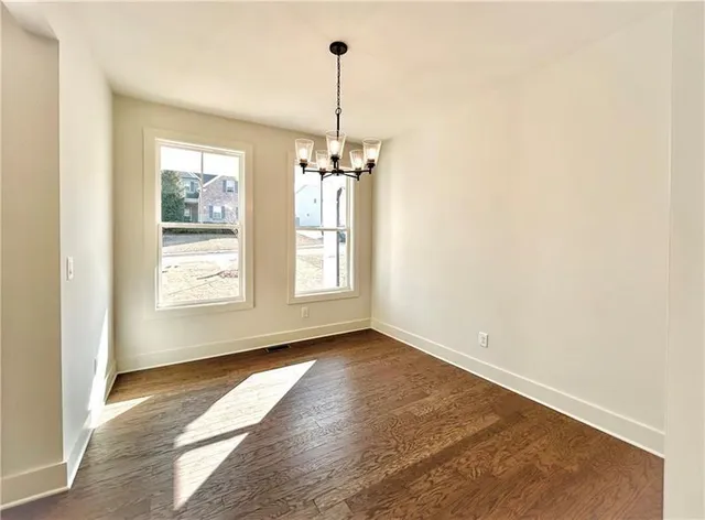 a view of a room with window wooden floor and a chandelier