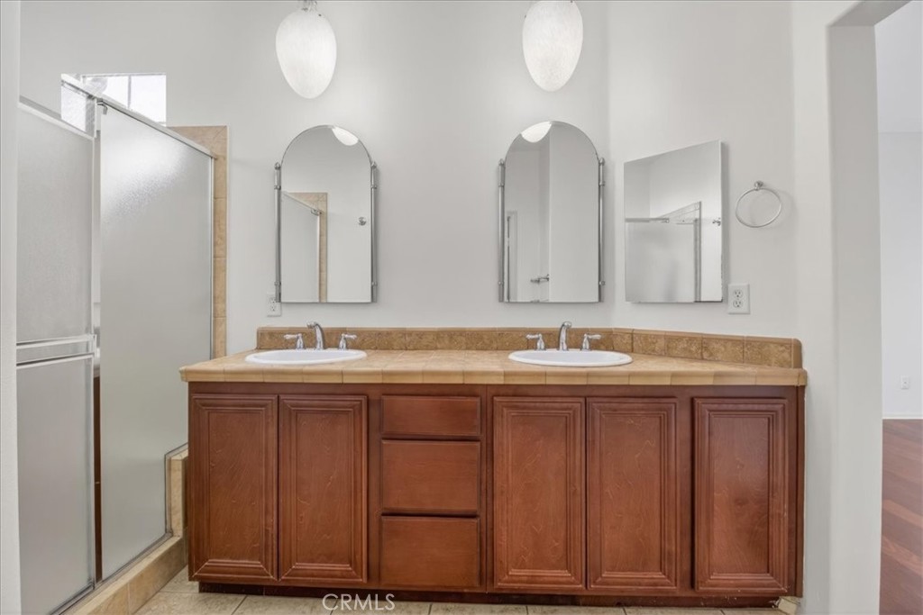 19266 Scripts Court Huntington Beach, CA 92648 - Photo 29 of 47 a bathroom with a double vanity sink and a mirror