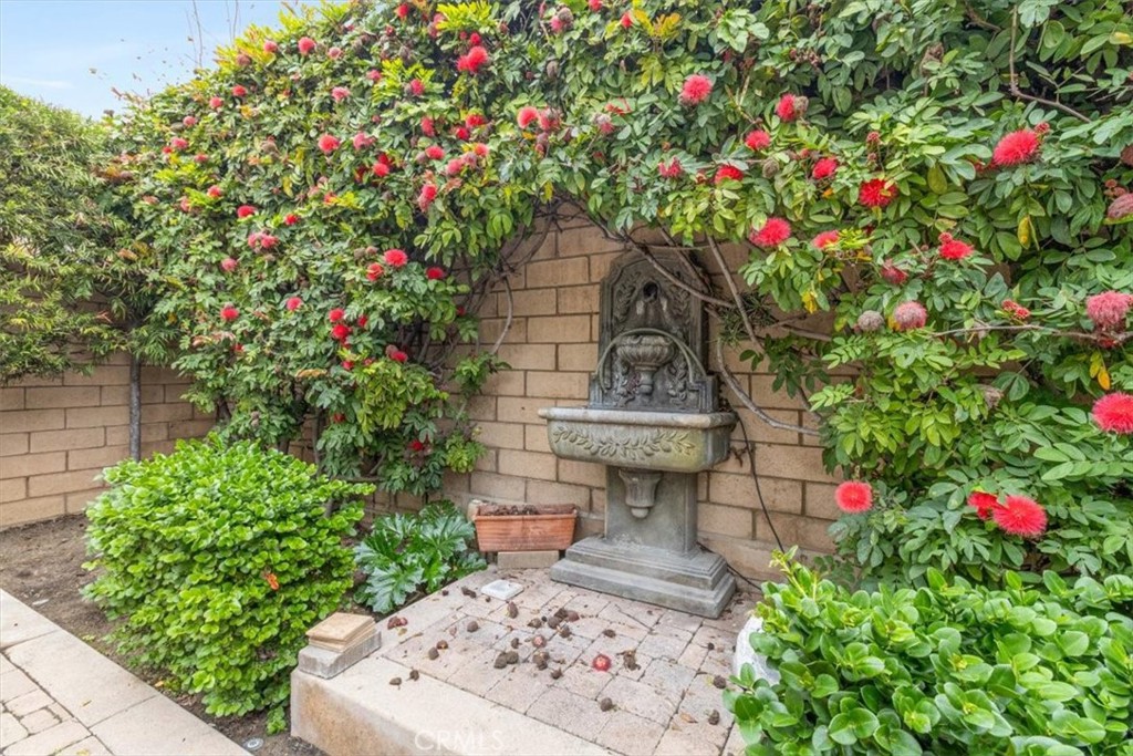19266 Scripts Court Huntington Beach, CA 92648 - Photo 34 of 47 a small garden with flowers and white wooden fence
