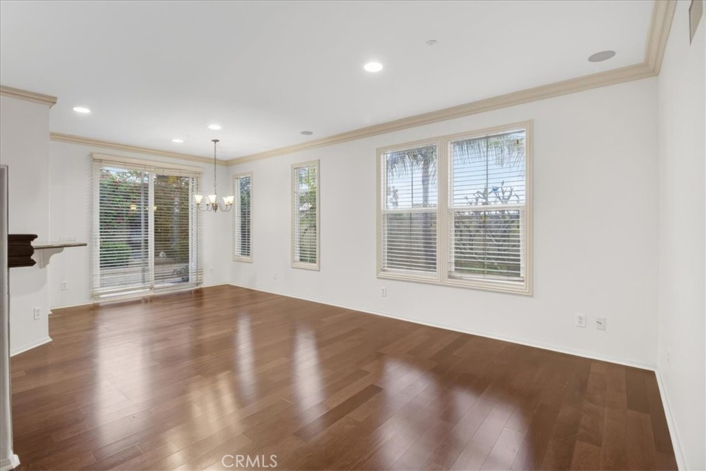 19266 Scripts Court Huntington Beach, CA 92648 - Photo 5 of 47 a view of an empty room with wooden floor and a window