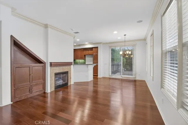 a view of empty room with wooden floor and fireplace