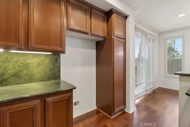a view of walk in closet with wooden floor