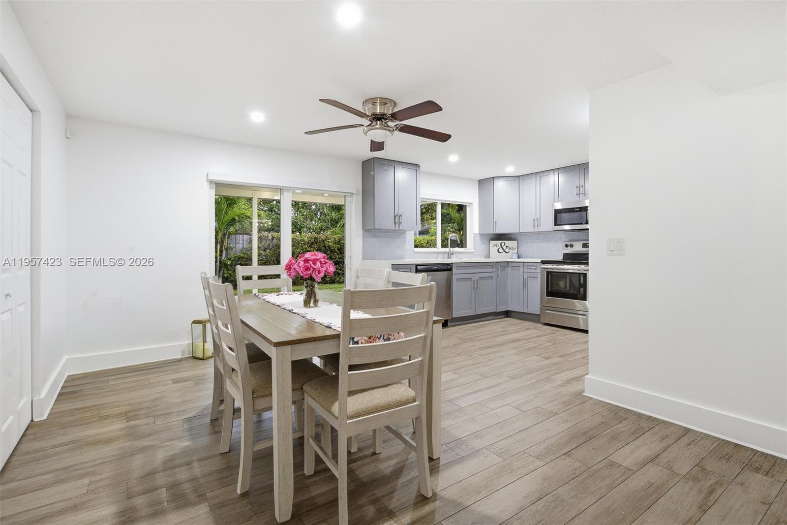 941 East 16th Place Hialeah, FL 33010 - Photo 13 of 32 a view of a dining room with furniture window and wooden floor