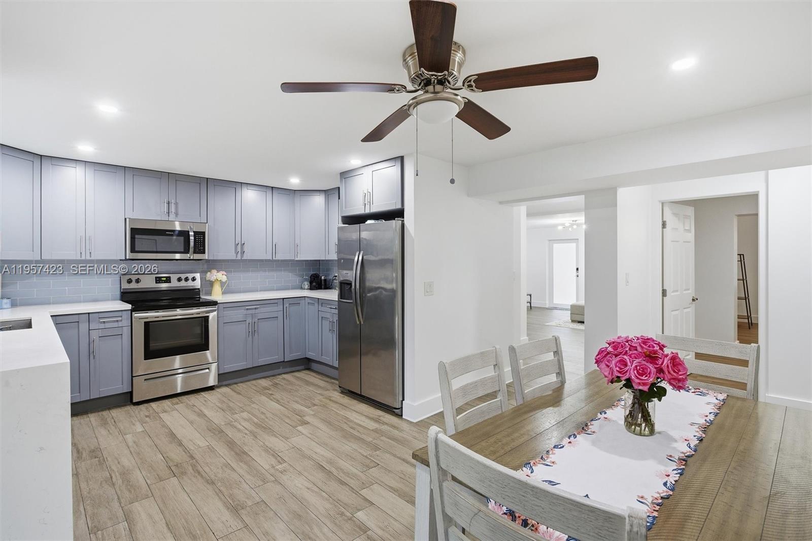 941 East 16th Place Hialeah, FL 33010 - Photo 14 of 32 a kitchen with a refrigerator cabinets and wooden floor