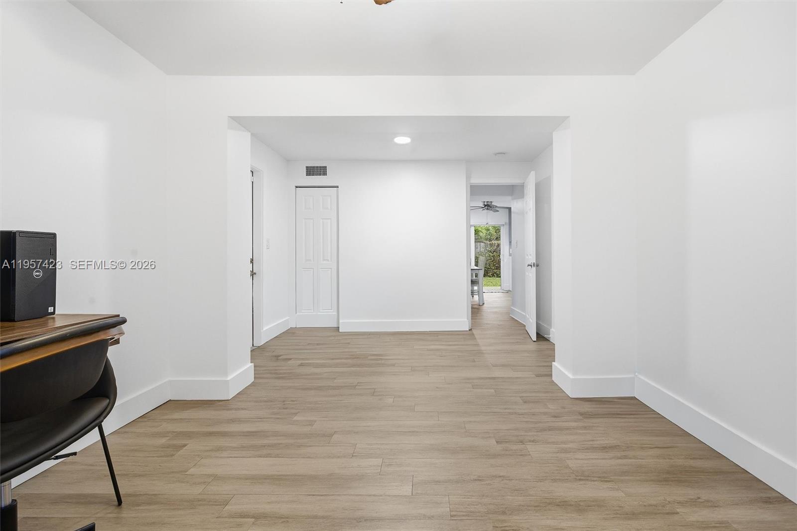 941 East 16th Place Hialeah, FL 33010 - Photo 17 of 32 a view of an empty room with wooden floor and a window