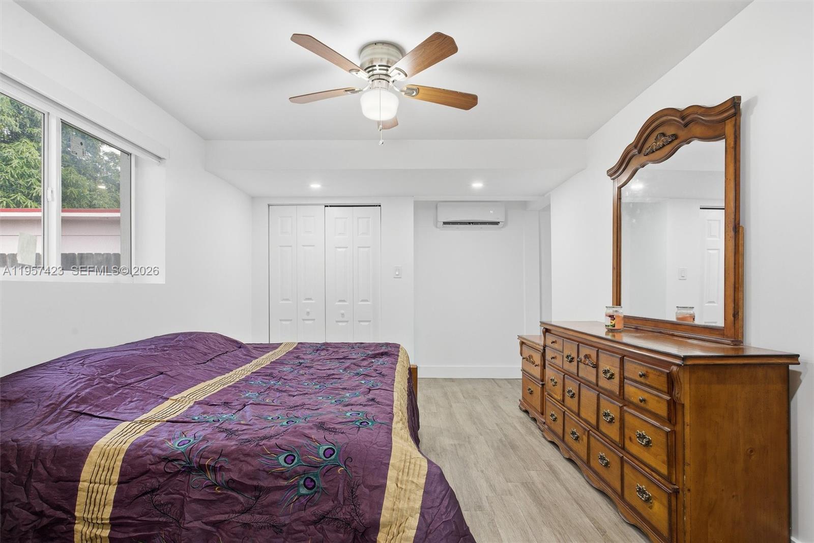 941 East 16th Place Hialeah, FL 33010 - Photo 20 of 32 a bedroom with a large bed dresser and a window