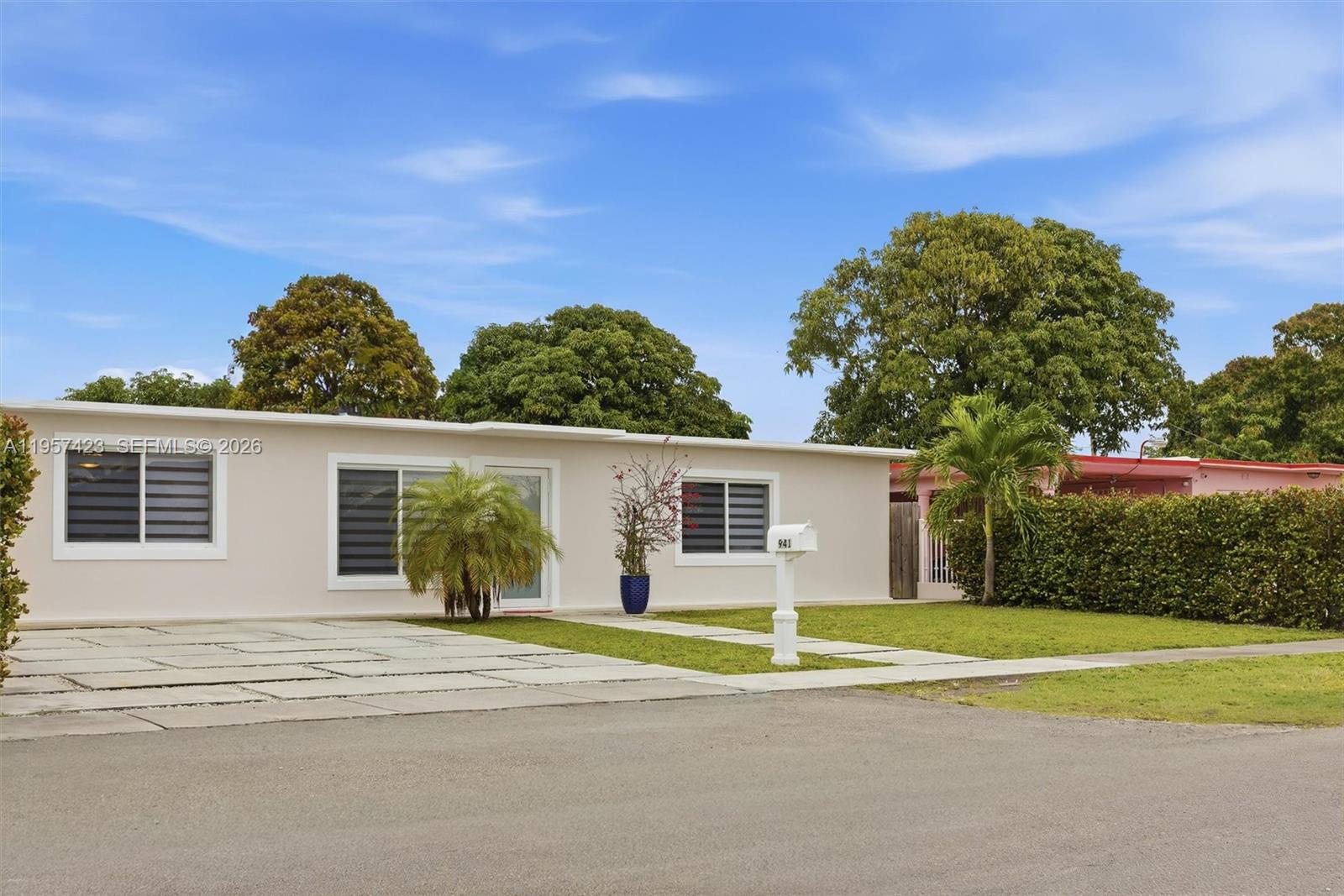 941 East 16th Place Hialeah, FL 33010 - Photo 2 of 32 a view of a house with a backyard and a tree
