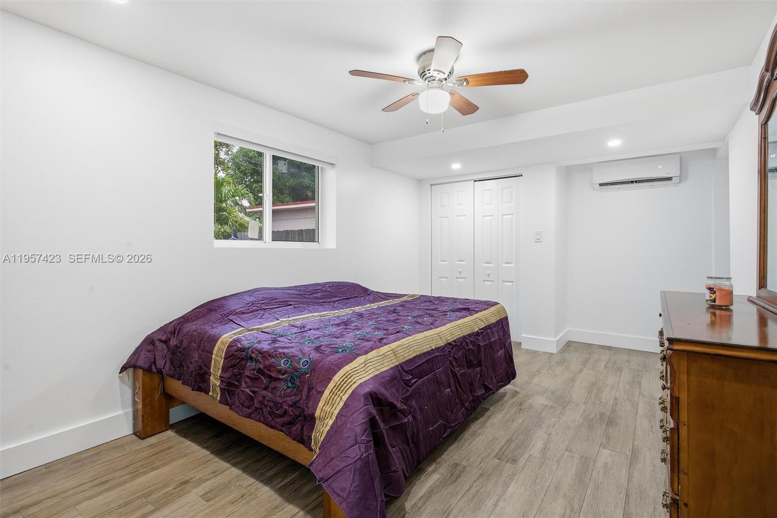 941 East 16th Place Hialeah, FL 33010 - Photo 21 of 32 a bedroom with a bed and a chandelier