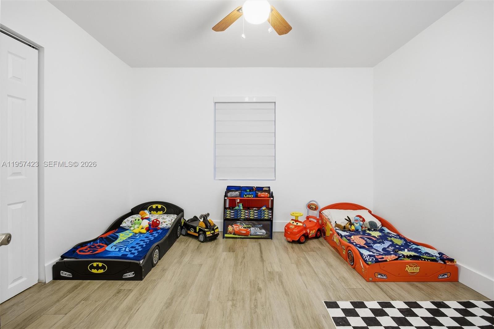 941 East 16th Place Hialeah, FL 33010 - Photo 24 of 32 a bedroom with a bed and a wooden floor