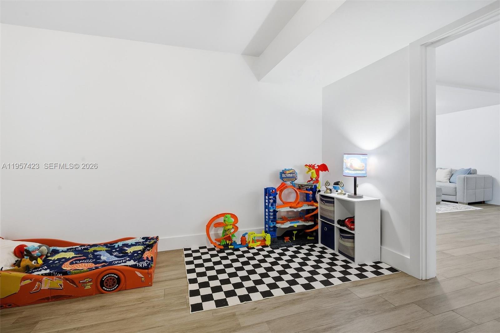 941 East 16th Place Hialeah, FL 33010 - Photo 25 of 32 a bedroom with furniture and a wooden floor