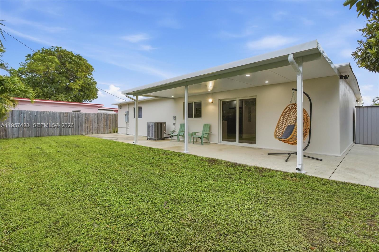 941 East 16th Place Hialeah, FL 33010 - Photo 26 of 32 a backyard of a house with table and chairs