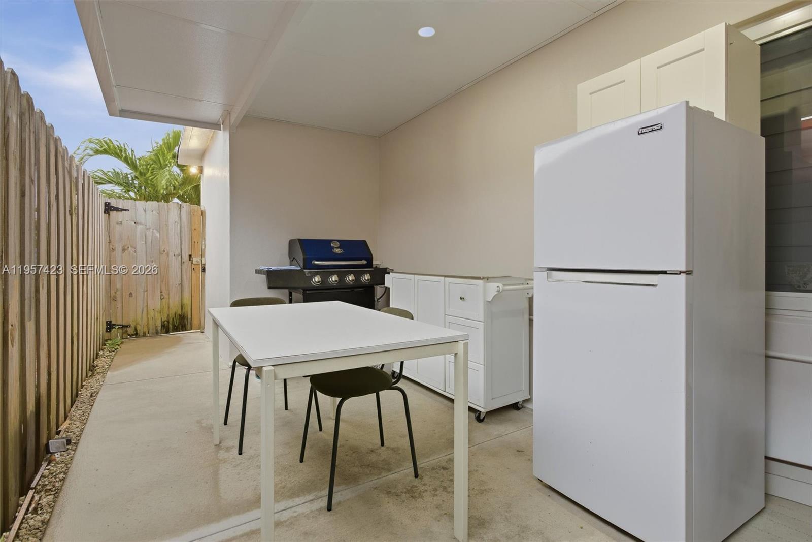 941 East 16th Place Hialeah, FL 33010 - Photo 29 of 32 a kitchen with refrigerator and table