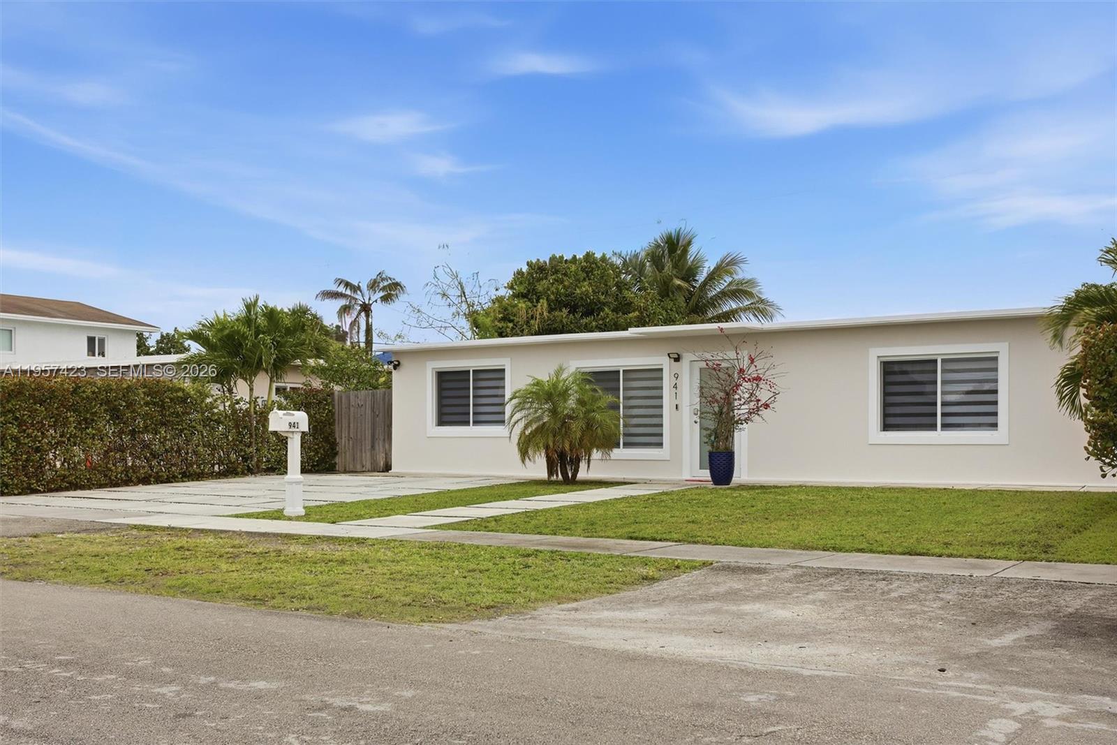 941 East 16th Place Hialeah, FL 33010 - Photo 3 of 32 a front view of house with yard and green space