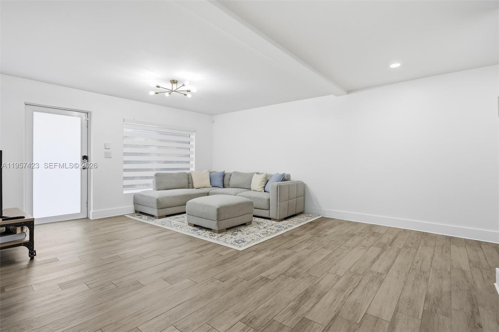 941 East 16th Place Hialeah, FL 33010 - Photo 6 of 32 a living room with furniture and wooden floor