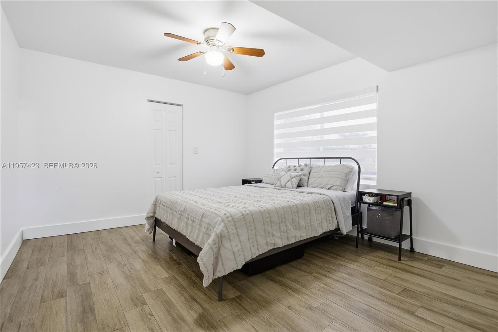 941 East 16th Place Hialeah, FL 33010 - Photo 7 of 32 a bedroom with a bed and a chandelier