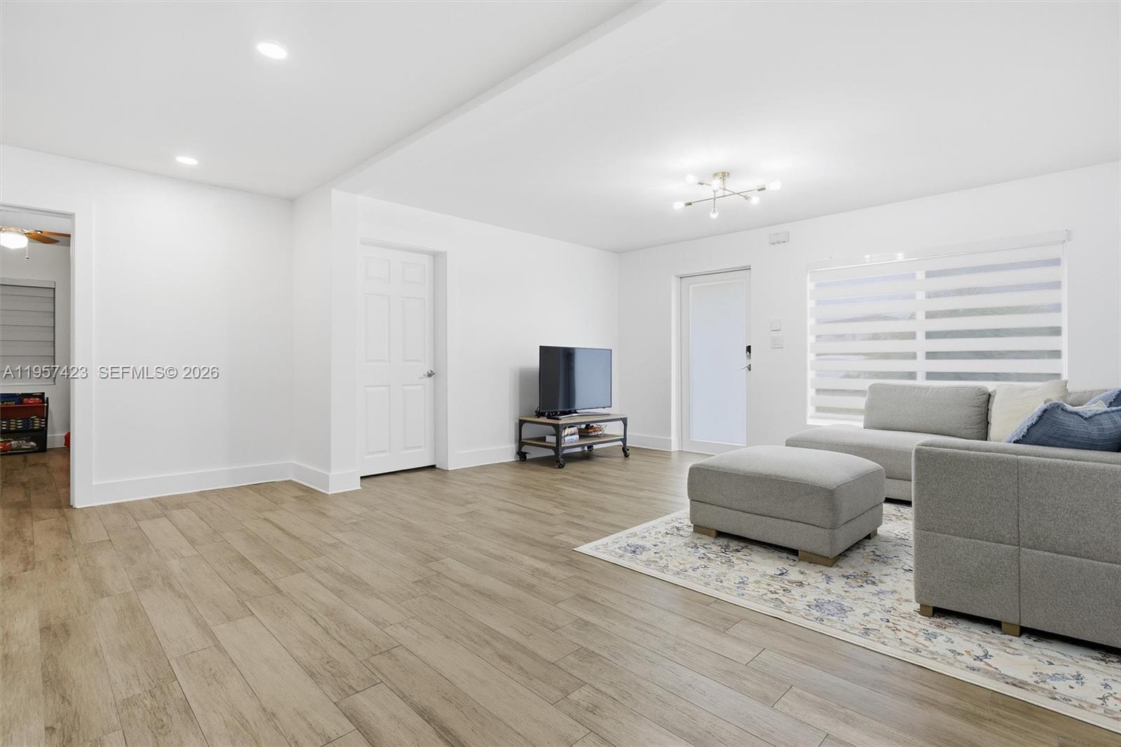 941 East 16th Place Hialeah, FL 33010 - Photo 8 of 32 a living room with furniture and a flat screen tv