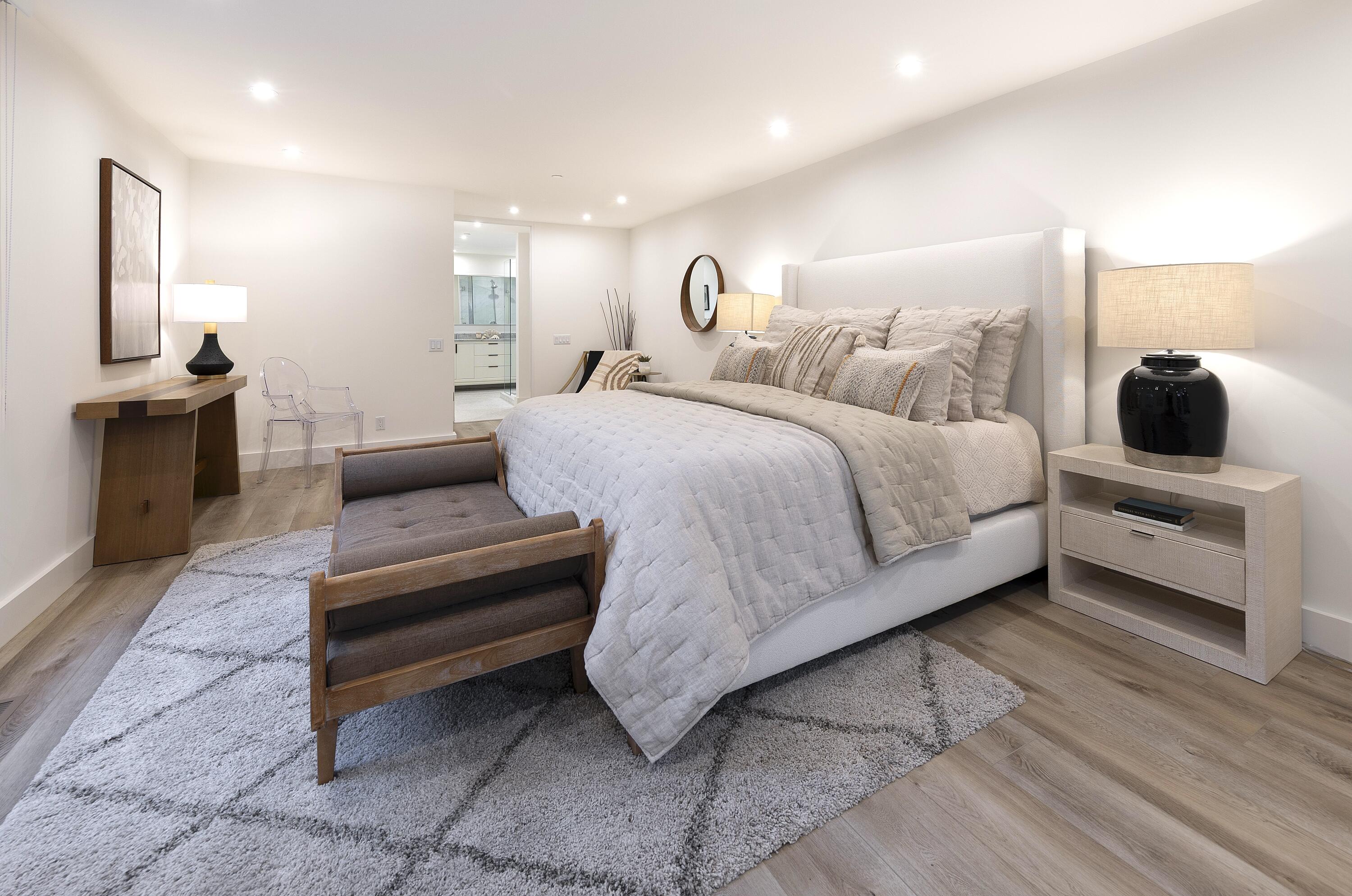 1524 East Valley Road Montecito, CA 93108 - Photo 10 of 19 a bedroom with a bed a couch and chandelier