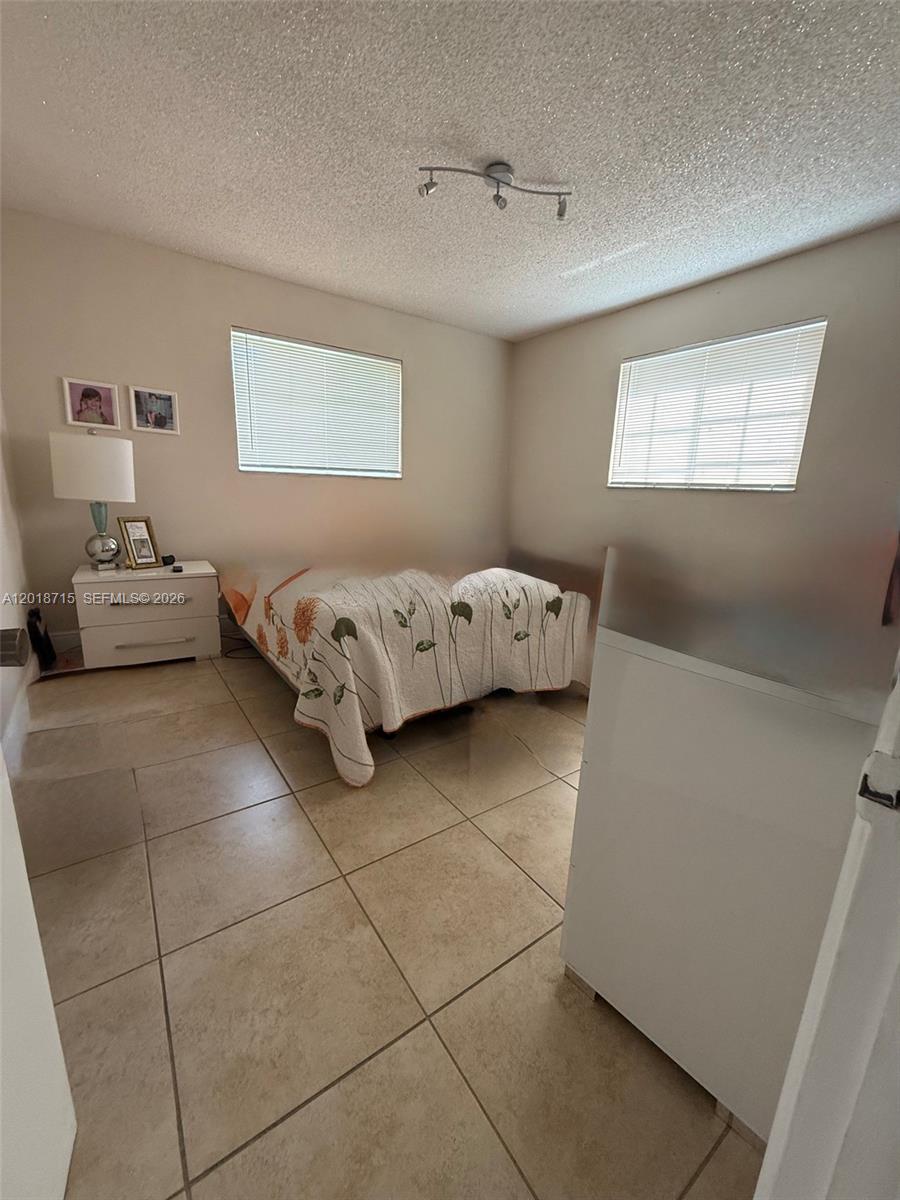 6720 Southwest 21st Street, Unit 1 Miami, FL 33155 - Photo 19 of 26 a spacious bedroom with a bed and window