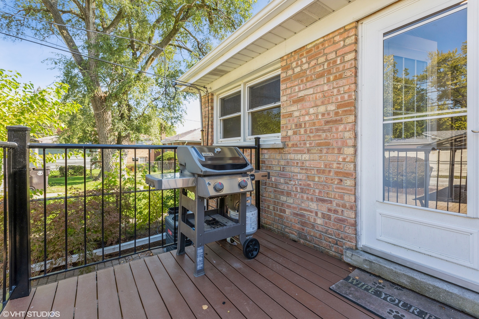 4150 Main Street Skokie, IL 60076 - Photo 23 of 28 a balcony with wooden floor and outdoor seating