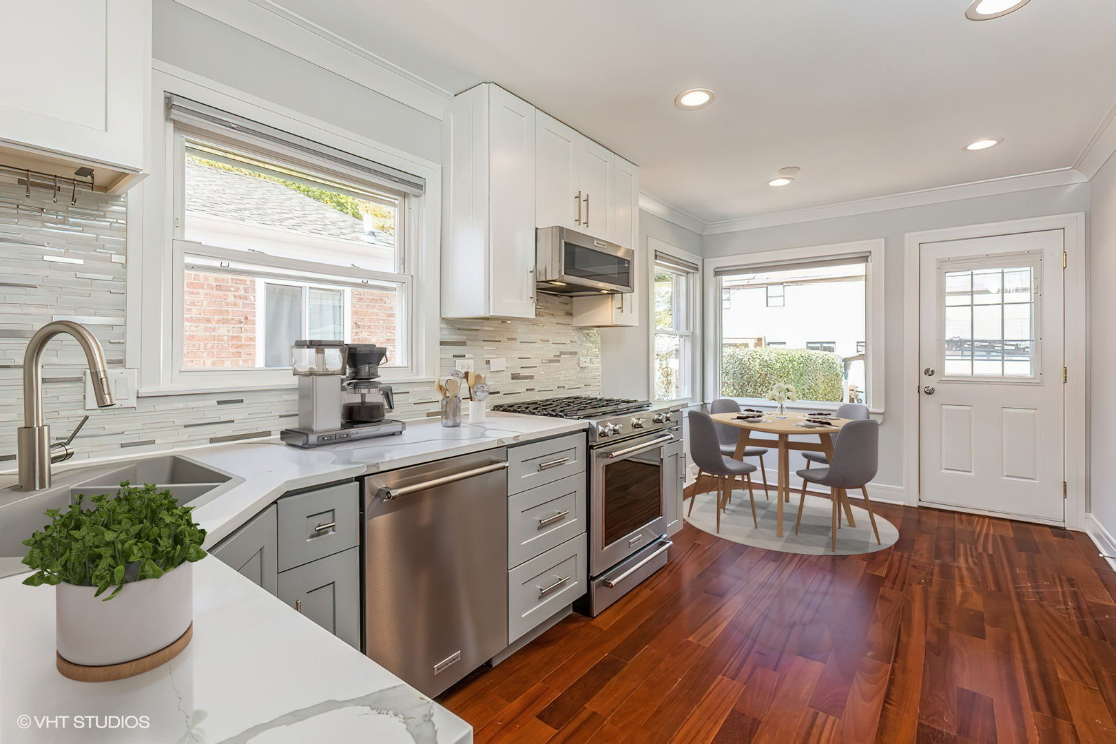 4150 Main Street Skokie, IL 60076 - Photo 9 of 28 a kitchen with sink cabinets and wooden floor