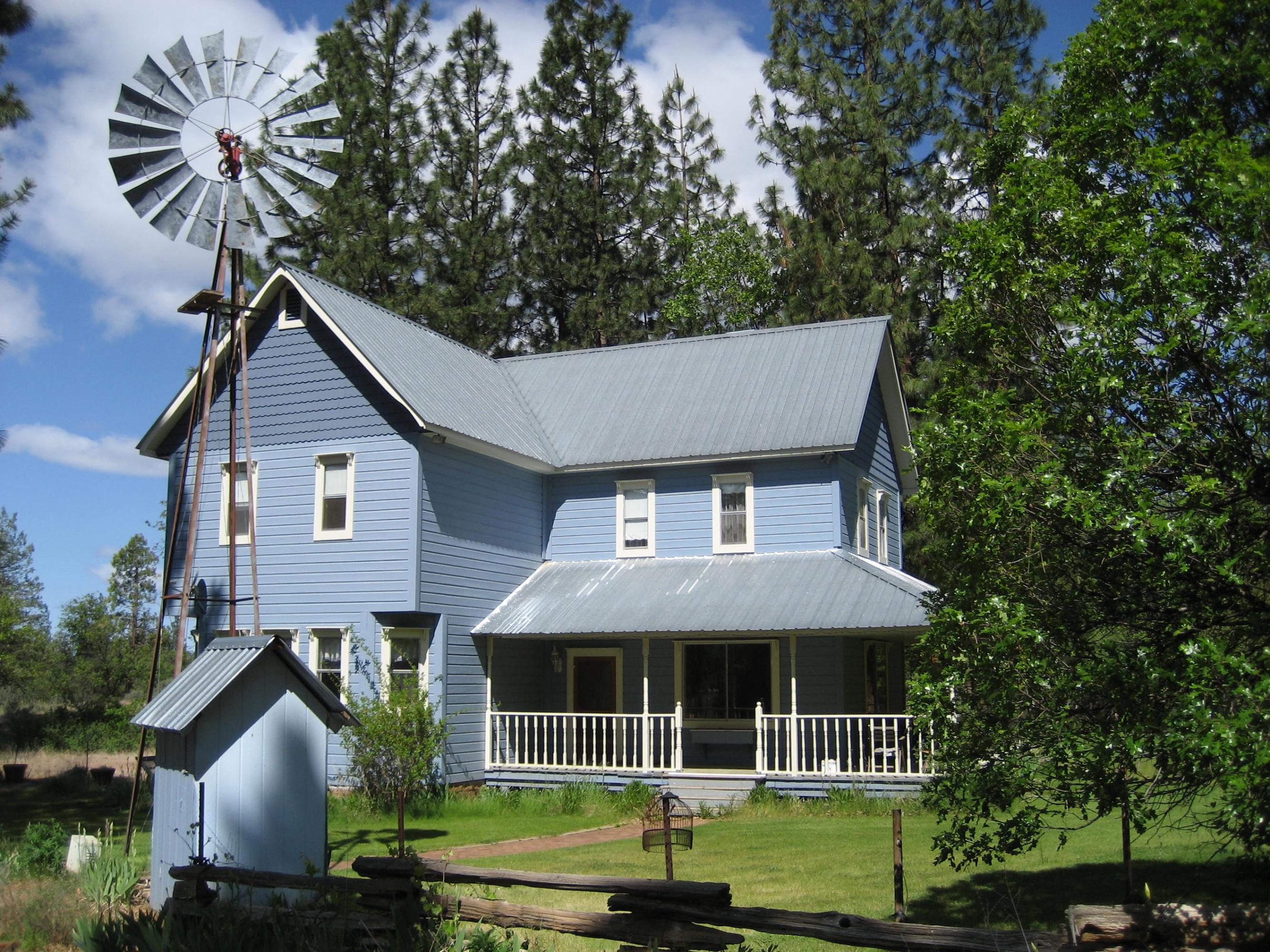 30204 Day Road McArthur, CA 96056 - Photo 2 of 25 a front view of a house with a garden and trees