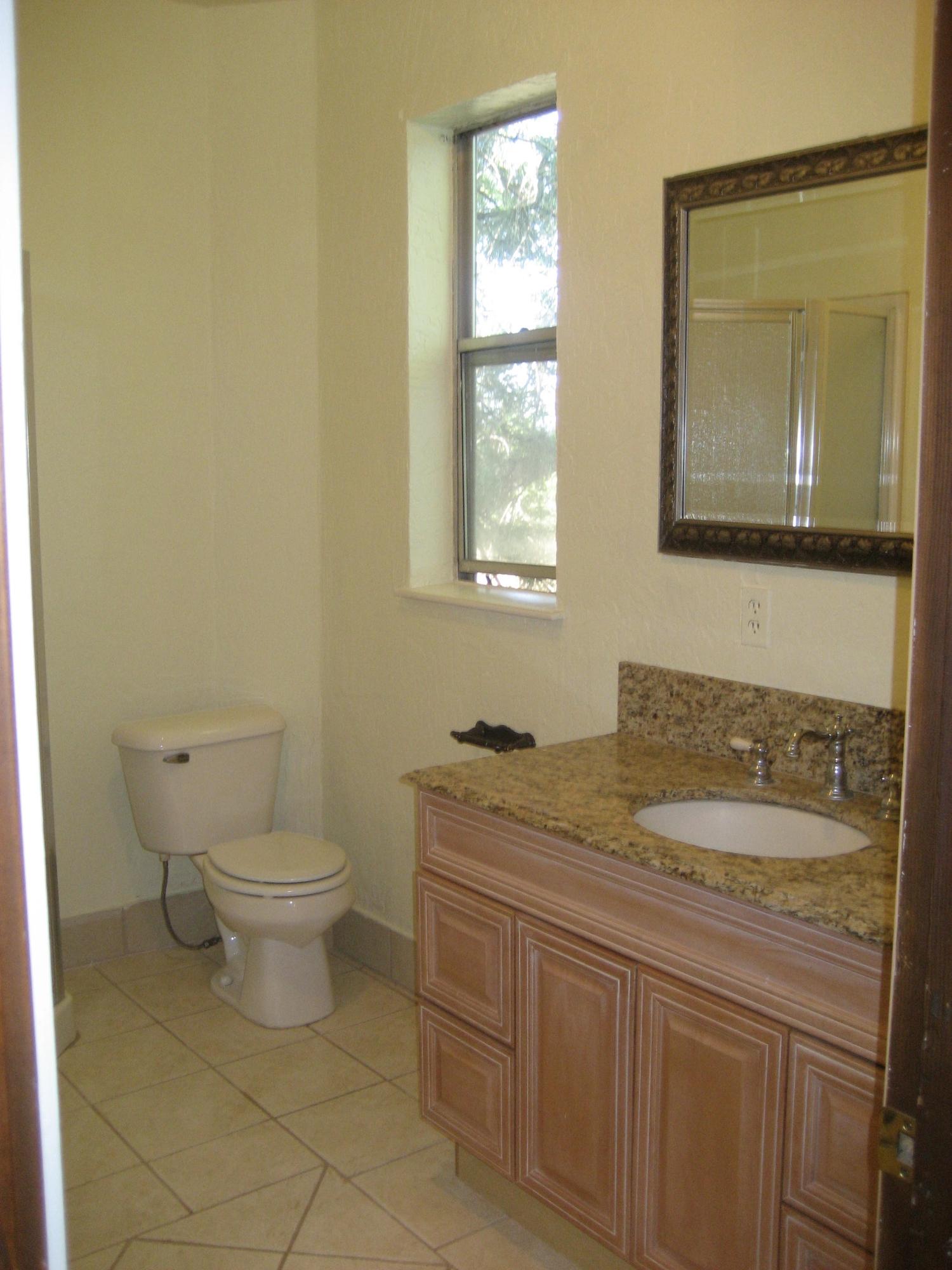 30204 Day Road McArthur, CA 96056 - Photo 24 of 25 a bathroom with a granite countertop toilet sink and mirror