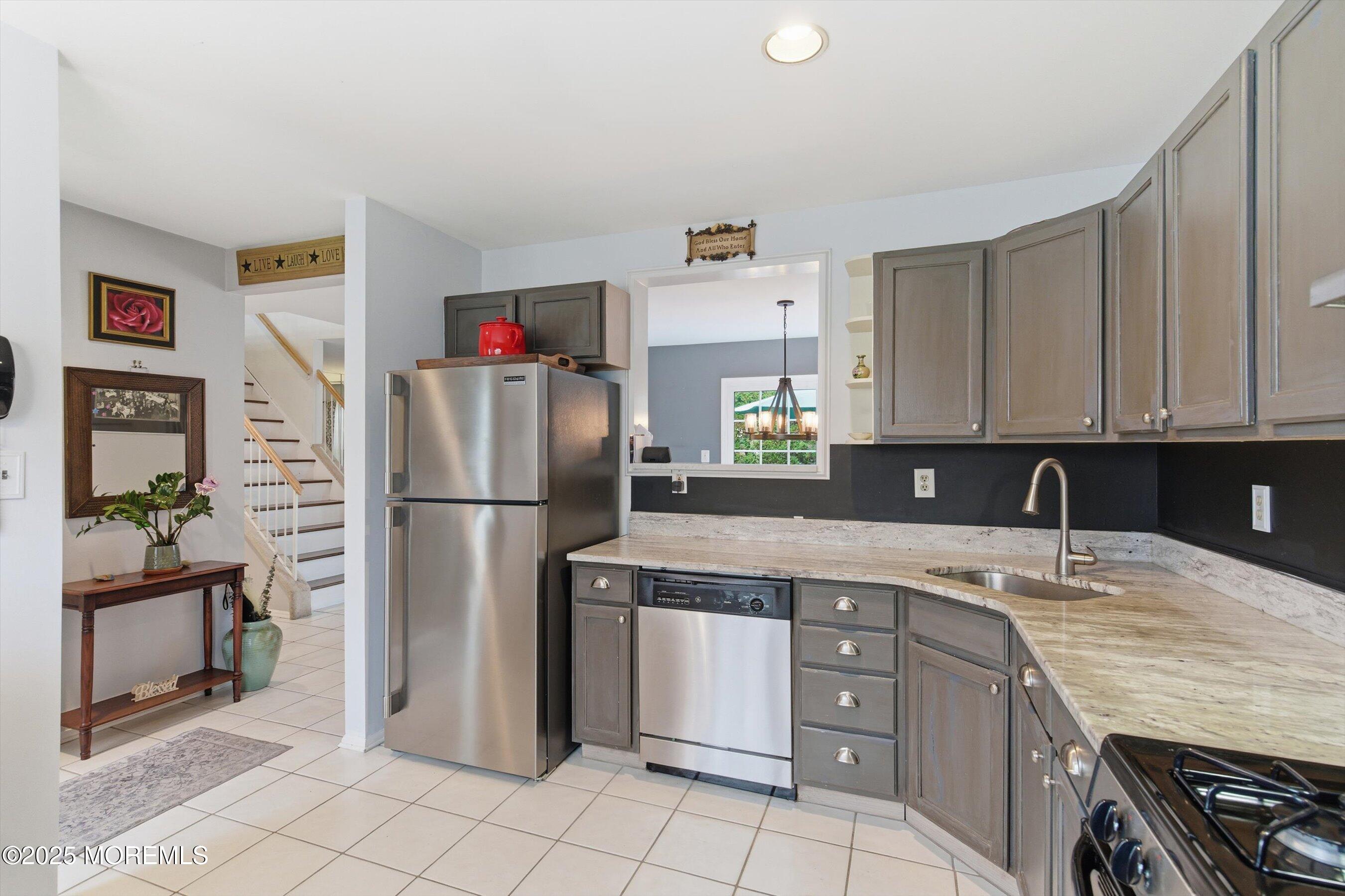 59 Perri Road Freehold, NJ 07728 - Photo 14 of 36 a kitchen with a sink appliances and cabinets