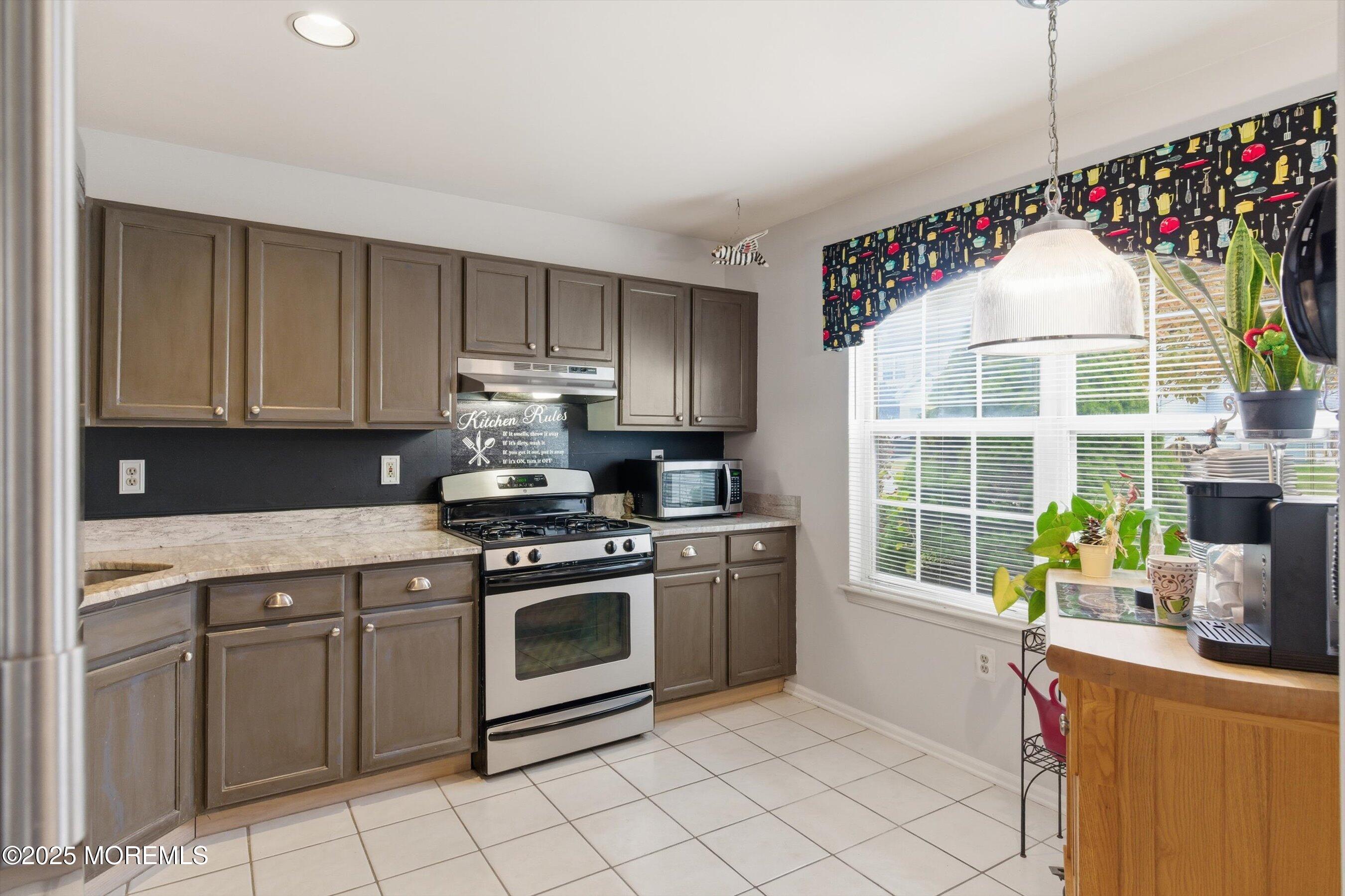 59 Perri Road Freehold, NJ 07728 - Photo 10 of 36 a kitchen with a stove a sink and a microwave