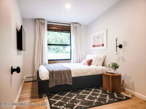a bedroom with a bed and a window