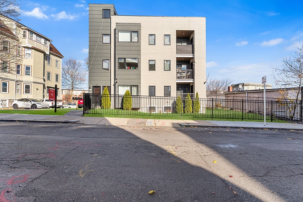 108 Maywood Street, Unit 2 Boston, MA 02119 - Photo 1 of 14 a view of a street with a building in front of it