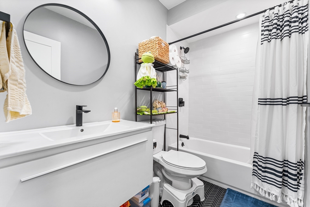 108 Maywood Street, Unit 2 Boston, MA 02119 - Photo 11 of 14 a bathroom with a sink a toilet and shower