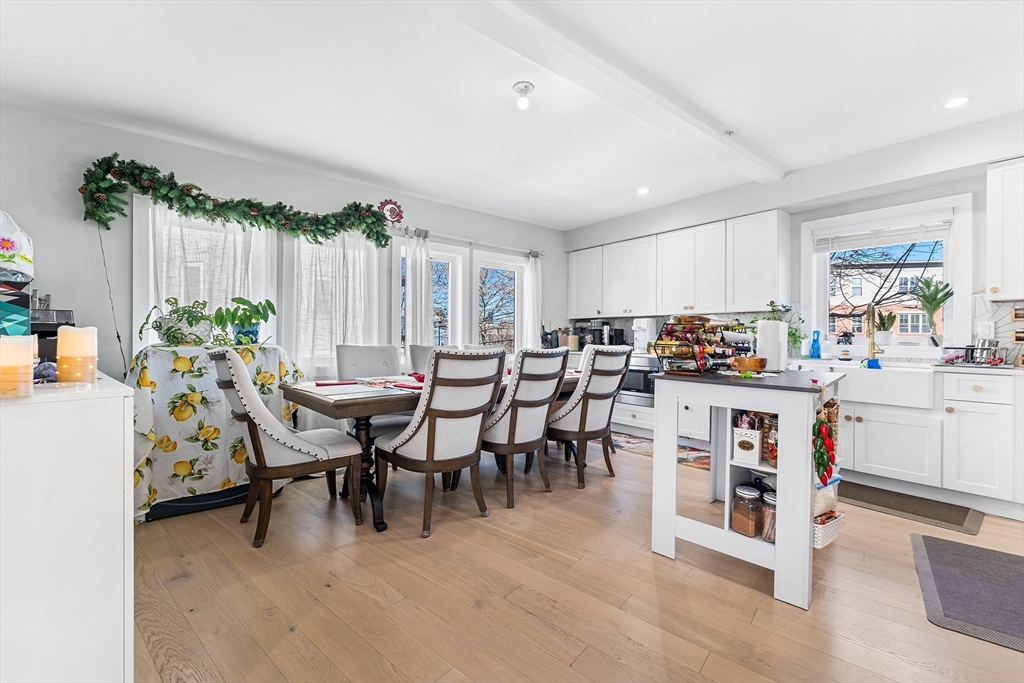108 Maywood Street, Unit 2 Boston, MA 02119 - Photo 5 of 14 a kitchen with white cabinets and chairs