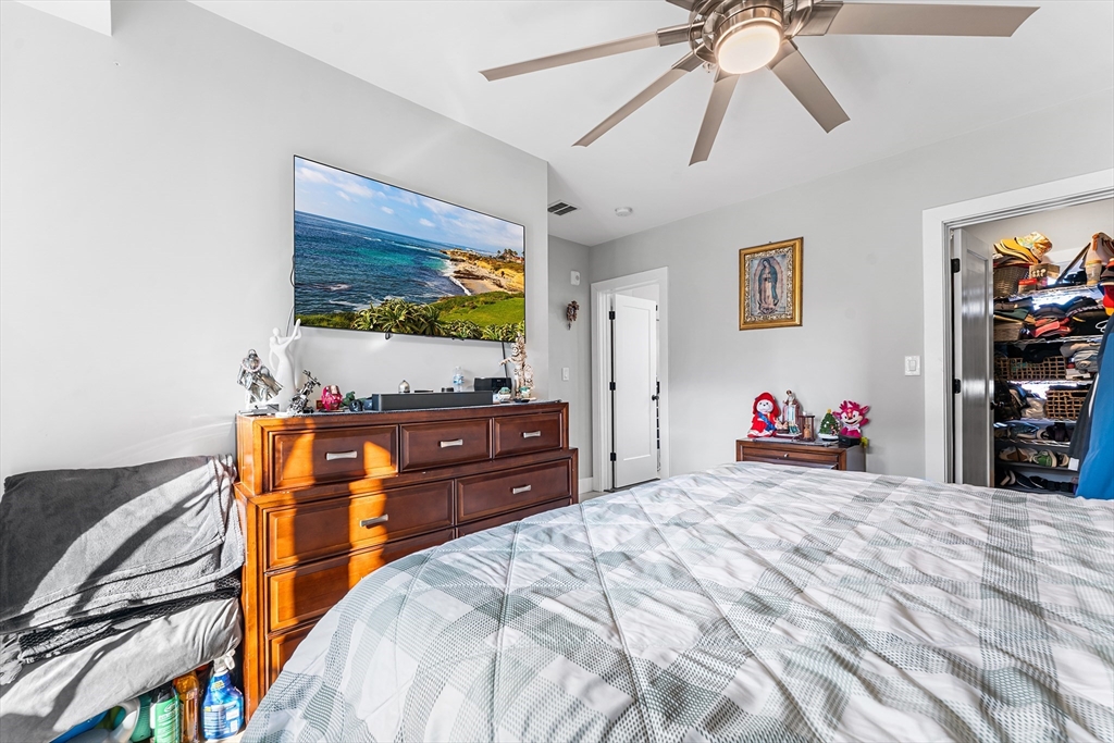 108 Maywood Street, Unit 2 Boston, MA 02119 - Photo 8 of 14 a bedroom with a bed and a flat screen tv