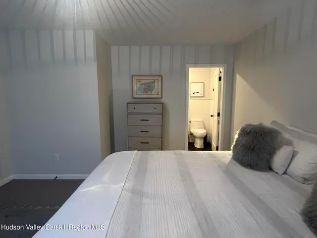 a bedroom with a bed and a tv