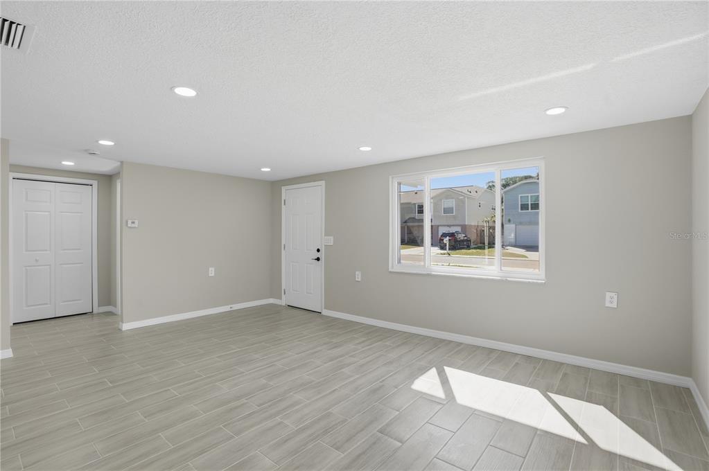 5543 Quist Drive Port Richey, FL 34668 - Photo 11 of 29 a view of an empty room with wooden floor and a window