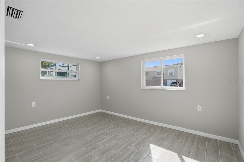 5543 Quist Drive Port Richey, FL 34668 - Photo 16 of 29 a view of a room with wooden floor and window
