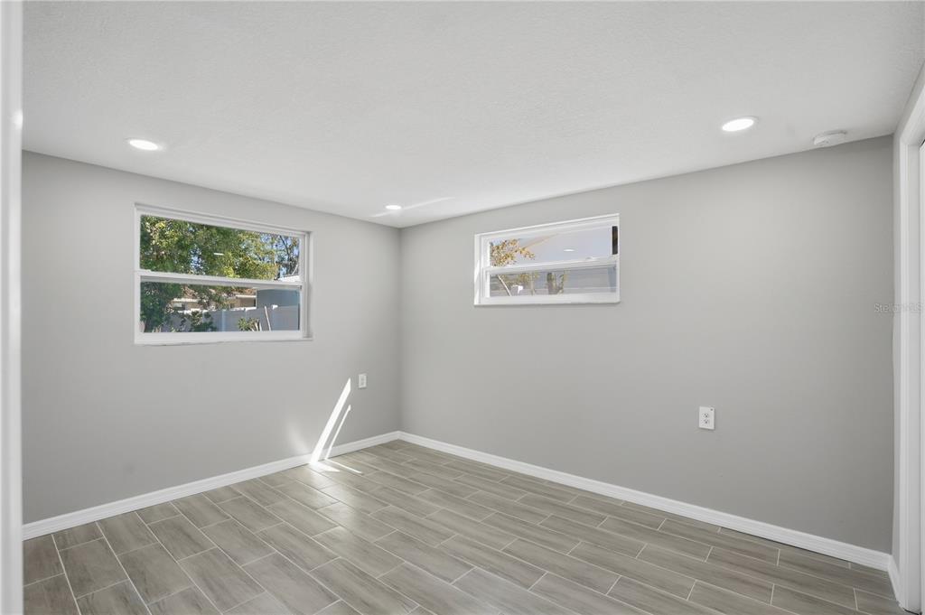 5543 Quist Drive Port Richey, FL 34668 - Photo 17 of 29 an empty room with wooden floor and window