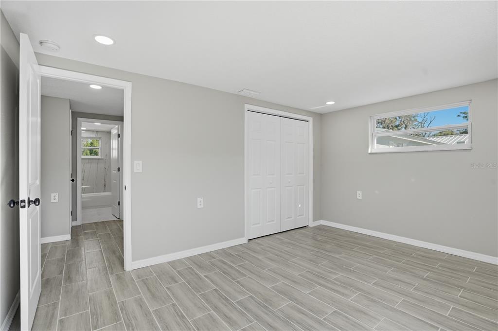 5543 Quist Drive Port Richey, FL 34668 - Photo 19 of 29 wooden floor in an empty room