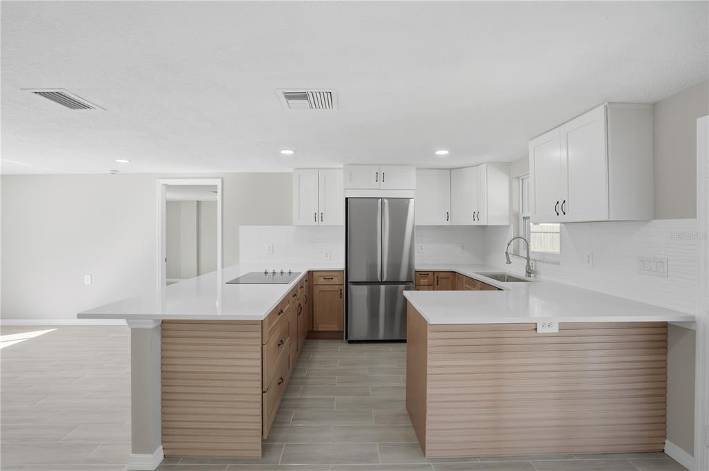 5543 Quist Drive Port Richey, FL 34668 - Photo 5 of 29 a kitchen with a refrigerator and a sink