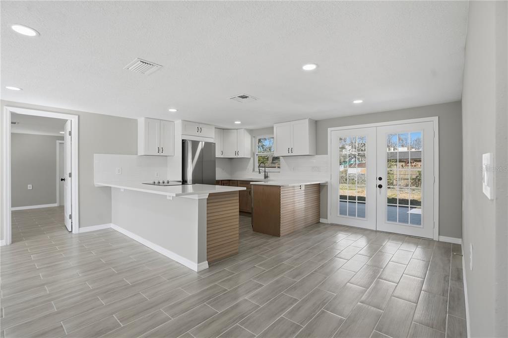 5543 Quist Drive Port Richey, FL 34668 - Photo 6 of 29 a kitchen with stainless steel appliances cabinets a sink and a counter top space