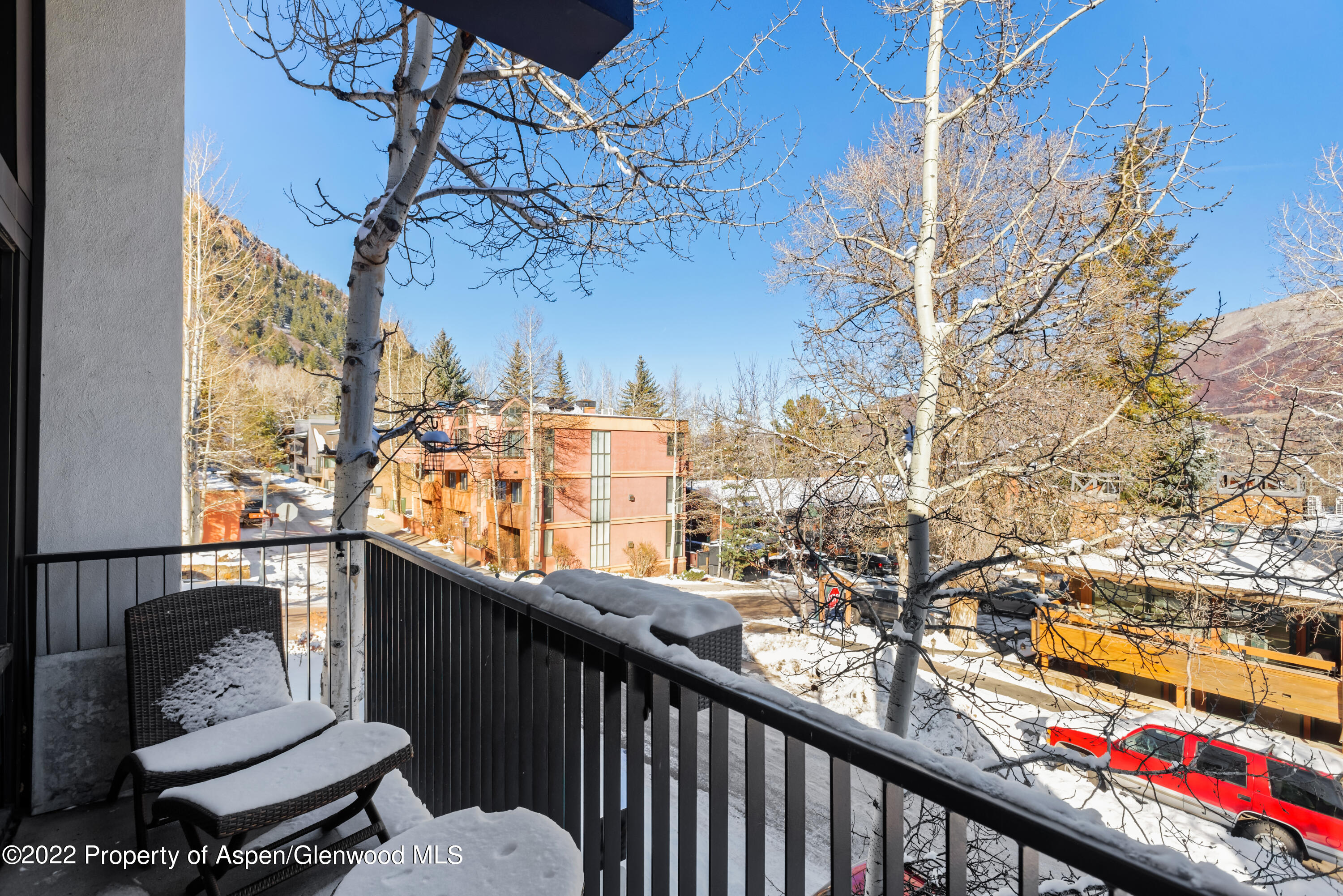 800 South Mill Street, Unit 6A Aspen, CO 81611 - Photo 15 of 18 a balcony with wooden floor and fence