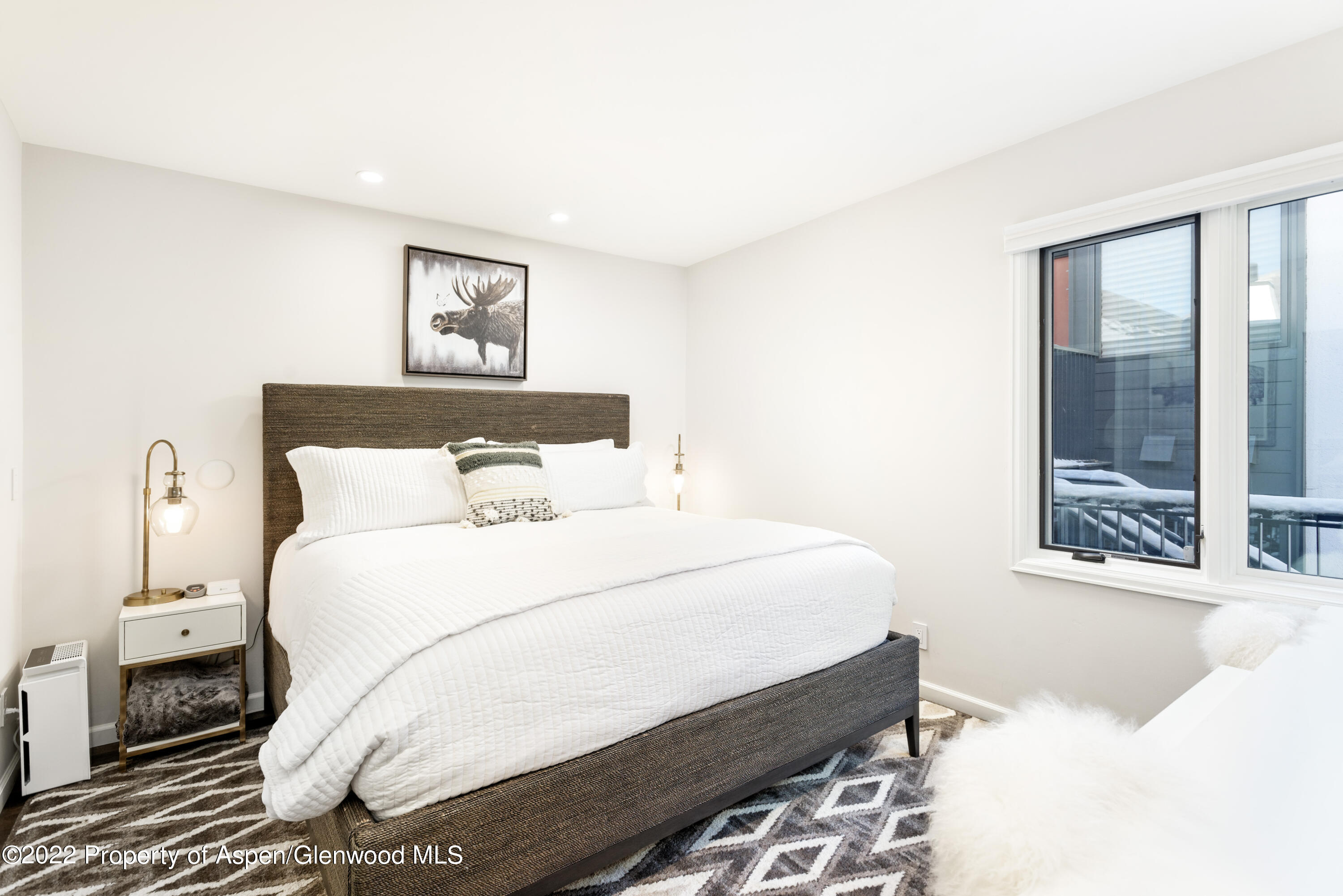 800 South Mill Street, Unit 6A Aspen, CO 81611 - Photo 7 of 18 a bedroom with a large bed and a window