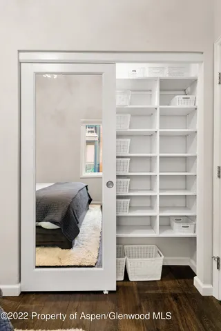 a view of a bedroom with a bed and a window