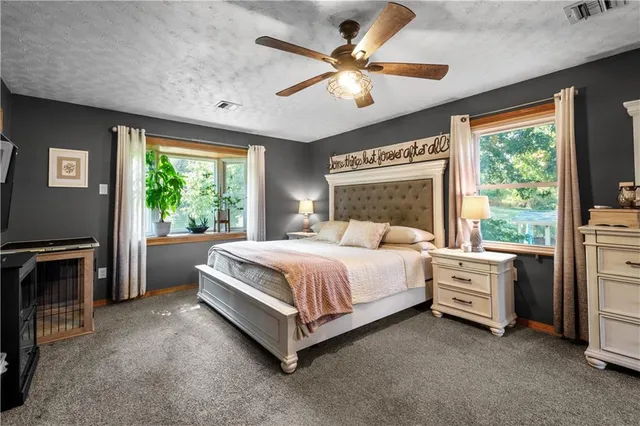 a bed room with a bed and a large window